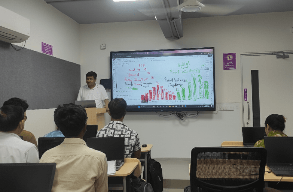 A modern classroom at Legacy85 with students engaged in a live trading session.